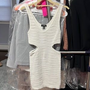 BeBe Ribbed Mini Dress with side cut outs. Size: P/S. Color: White